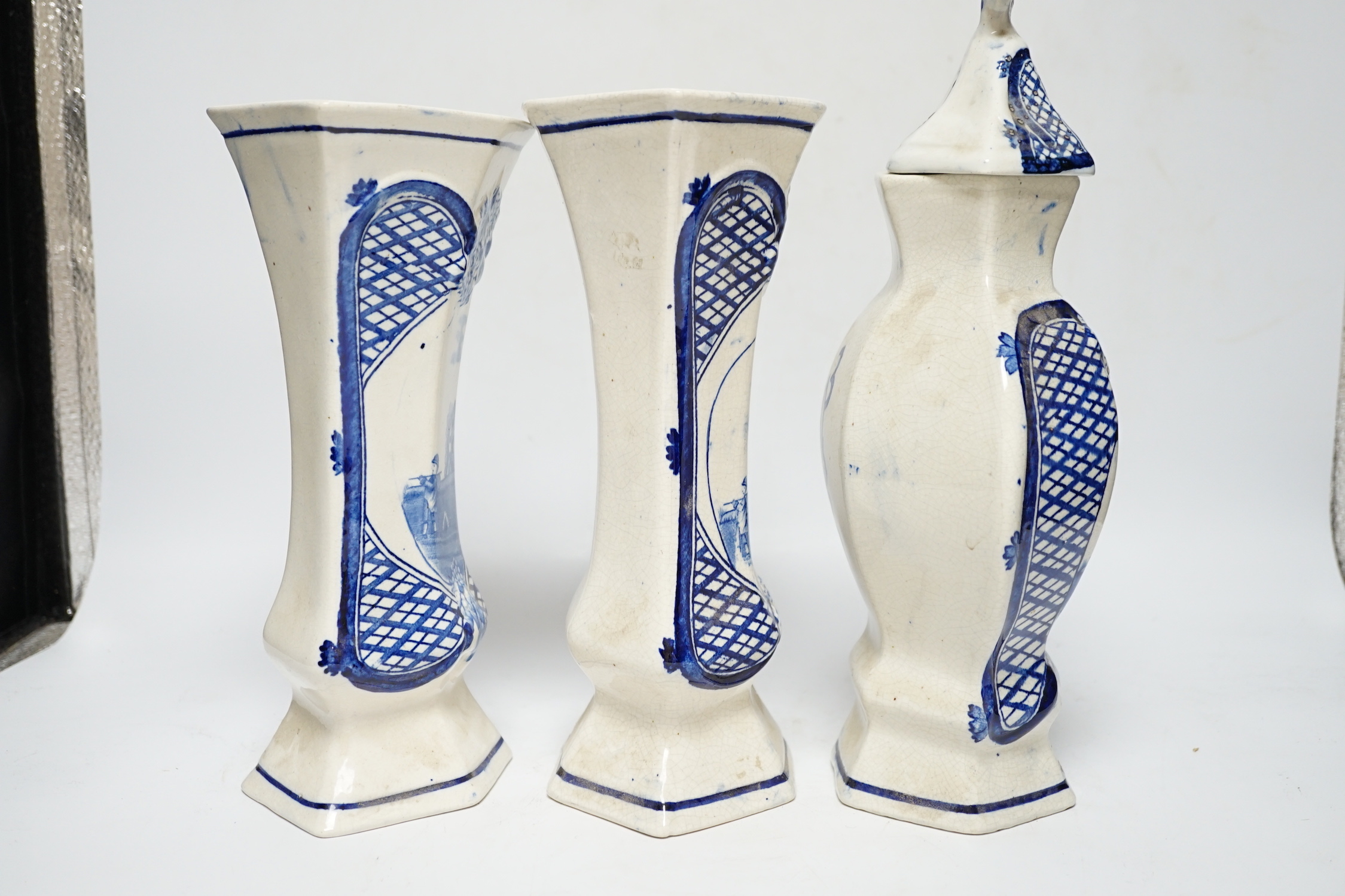 A trio of cream and blue glazed pottery vases, one with cover, tallest 34cm high